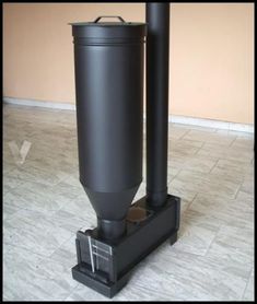 a large black cylinder sitting on top of a tile floor in front of a wall