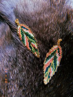 two pairs of colorful beaded leaves on the back of a dog's ear