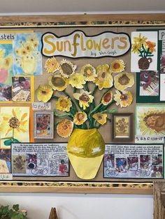 a yellow vase filled with flowers sitting on top of a wooden shelf next to pictures