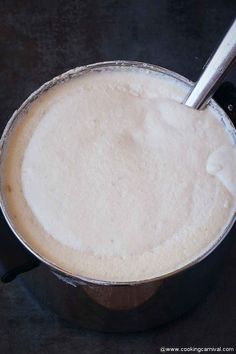 a pot filled with liquid sitting on top of a table