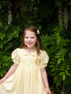 This classic lemon yellow dress is all handmade with intricate hand smocking and embroidered pearls on the chest. This dress is perfect for everyday wear and can be dressed up for formal occasions as well. *  100% Cotton *  2 Layers *  Handmade *  Tie at the back *  Lightweight, soft cotton, comfortable, and ready to play *  Hand wash or machine wash on a delicate setting We are based in Sydney, New South Wales, Australia. We ship within Australia and to other countries as well. The shipping fee Yellow Smocked Bodice Dress For Daywear, Classic Spring Dress With Smocked Back, Classic Summer Dress With Smocked Back, Yellow Smocked Short Sleeve Dress For Spring, Yellow Smocked Dress For Daywear, Yellow Smocked Dress With Short Sleeves For Spring, Yellow Short Sleeve Smocked Dress For Spring, Classic Smocked Summer Dresses, Classic Smock Dresses For Summer