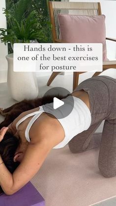 a woman is doing yoga on the floor with her head in her hands and arms behind her back