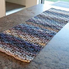 a multicolored rug sitting on top of a counter next to an open door