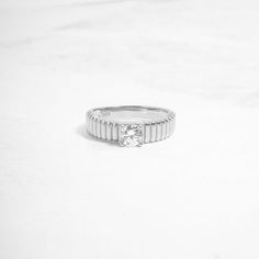 This ring is available in gold or silver and features a fluted texture with a solitaire round cubic zirconia stone. It's absolutely beautiful and looks great stacked or on its own! It's a statement ring yet minimalist and chic all in one! • Made of 925 Sterling Silver• THICK plating of 14k Gold or Rhodium• Available in Sizes 4-12• Made of highest quality cubic zirconia• VERY HIGH QUALITY• Nickel-free & Hypoallergenic • 5mm Thickness Minimalist Ring With Center Stone In Round Band, Minimalist Rings With Center Stone In Round Band, Minimalist Cubic Zirconia Diamond Ring, Minimalist Channel Set Round Cut Wedding Ring, Minimalist Channel Set Round Diamond Ring, Minimalist Channel Set Diamond Ring, Modern Solitaire Crystal Ring, Minimalist Solitaire Couple Rings, Minimalist Round Cut Crystal Ring For Formal Occasions