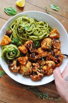 a white bowl filled with pasta and chicken