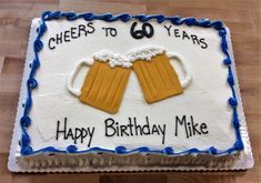 a birthday cake with two beer mugs on it