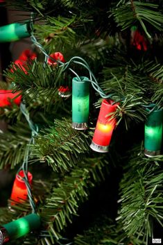 christmas lights are hanging from the branches of a tree