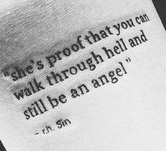 a person with a tattoo saying she's proof that you can walk through hell and still be an angel