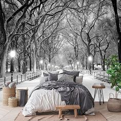 a large bed sitting in the middle of a park covered in snow next to benches