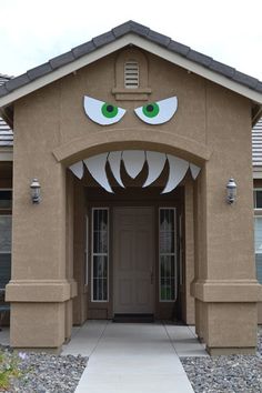 the front entrance to a house with fake eyes on it