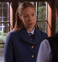 a woman in uniform looking at the camera