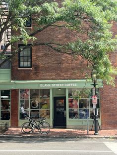 a bicycle is parked in front of a bank street coffee shop