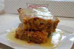 two pieces of cake sitting on top of a white plate covered in yellow sauce and butter