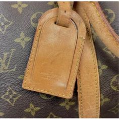 Timeless early 20th century Louis Vuitton Keepall travel Bag in classic monogrammed leather. Gold brass hardware, padlock and leather trim/tag all have the unique Louis Vuitton monogram. No key available.  Has double leather handles, 4.75" drop. Lightweight overnight or weekender bag. Classic Bags In Monogram Canvas With Lock, Classic Bag With Lock In Monogram Canvas, Classic Bags With Lock In Monogram Canvas, Classic Monogram Canvas Bag With Lock, Louie Vuitton, Louis Vuitton Keepall, Monogrammed Leather, Gold Brass, Leather Handles