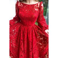 a woman wearing a red lace dress