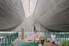 the inside of a house with plants and furniture