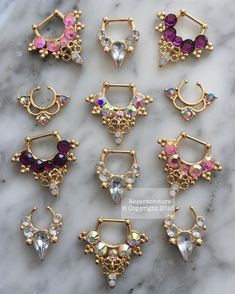 six pairs of gold plated earrings with multicolored stones