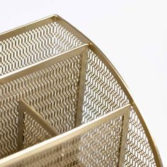 a close up of a metal basket on a white surface with no people around it