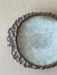 a white and brown bowl sitting on top of a table