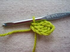 the crochet hook is being used to hold the yarn