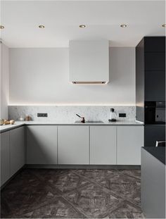 a kitchen with white cabinets and marble counter tops