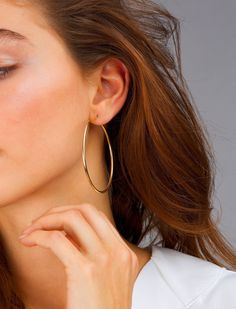 "The perfect earrings for women, gift these hoop earrings to someone special or yourself, these large hoops are classic due to their thin design. Get them in 14k gold vermeil or sterling silver. DETAILS: All hoops are sold in pairs. Diameter: 57mm Width: 1.9mm QUALITY: * 100% 14k Gold Vermeil or Sterling Silver available What is 14k Gold Vermeil? We thought you would ask! :) 14k Gold Vermeil (pronounced \"ver-may\"), should not be confused with gold plating or filled. Vermeil is a much thicker l Large Gold Hoop Earrings, Blush Jewelry, Earrings Classic, Gold Name Necklace, Hoop Earrings Gold, Elegant Nails, Creating Jewelry, White Jewelry, Solid Gold Jewelry