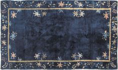 a blue rug with gold trimmings and stars on it