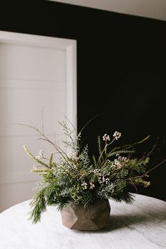 a vase filled with flowers sitting on top of a table