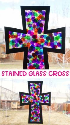 the stained glass cross is displayed in front of a window