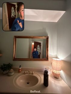 a woman is taking a selfie in the bathroom mirror with her reflection on the wall