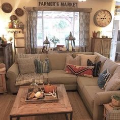 a living room filled with furniture and lots of pillows on top of it's couches