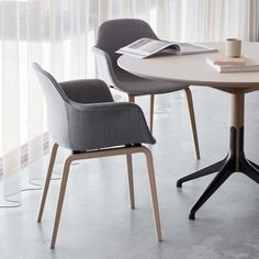 a table with two chairs and a book on it