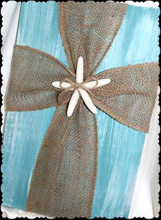 a blue and brown gift wrapped in burlock with a bow on it's side