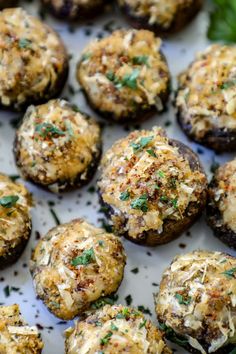 an assortment of stuffed mushrooms with cheese and herbs