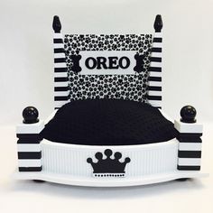 a black and white bed with a crown on it