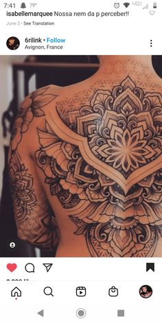 the back of a man with tattoos on his chest