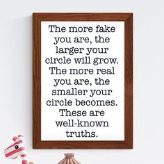 a wooden frame with a quote on it that says, the more fake you are, the larger your circle will grow