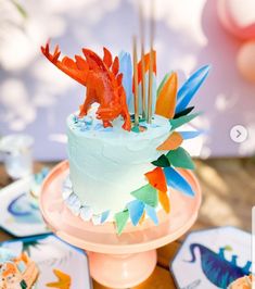 there is a cake with orange and blue decorations on it