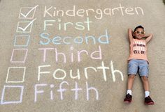 a little boy laying on the ground next to chalk writing that says, first second third fourth fifth