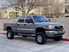 a gray truck parked in front of a building