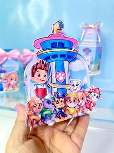 a hand holding up a clear case with cartoon stickers on it