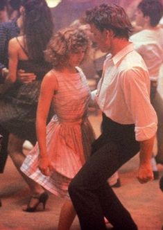 a man and woman dancing on the dance floor