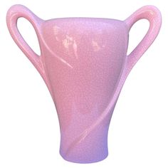 a pink vase with curved handles is shown