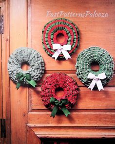 three wreaths are hanging on the wall