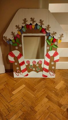 a cardboard gingerbread house decorated with candy canes