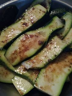 sliced cucumbers in a bowl with seasoning on the side, ready to be eaten