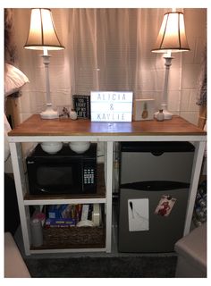 a table with a sign on it and two lamps next to it in a living room