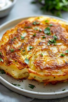 a white plate topped with two cheesy cakes on top of a table next to other dishes