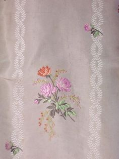 a white table cloth with pink flowers on it