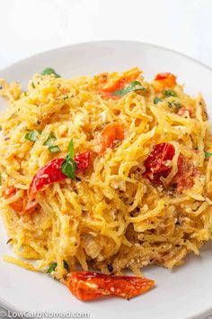 a white plate topped with spaghetti and vegetables